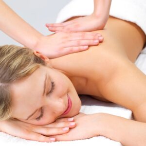 Woman smiling happily while getting a back massage. 