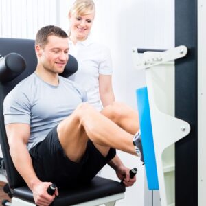 male working out with physical therapist