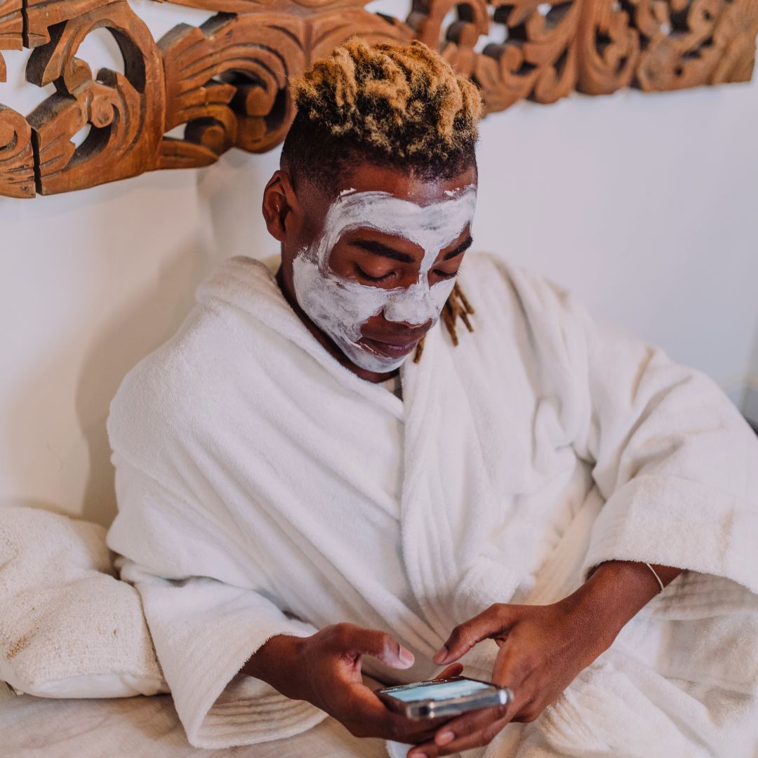 man with a facial on his phone